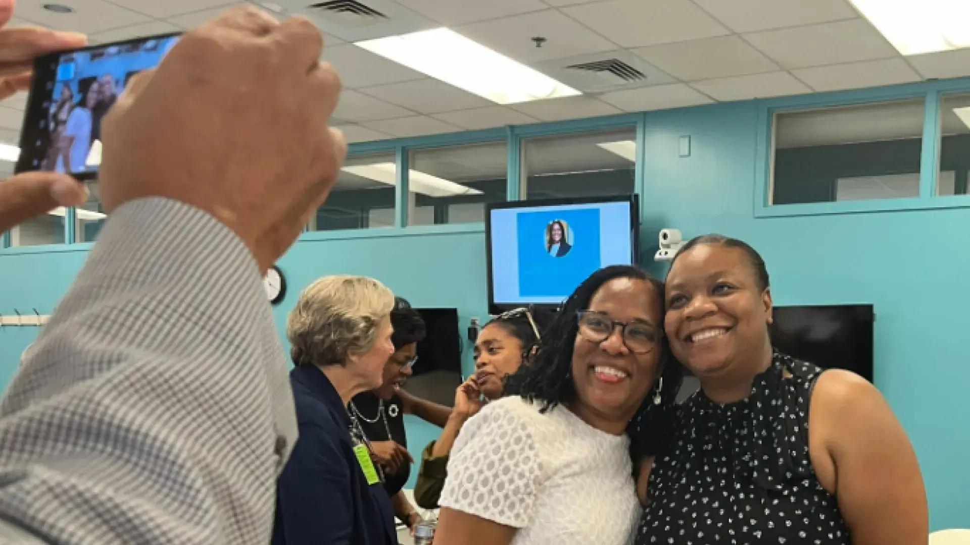 two women smile at a camera