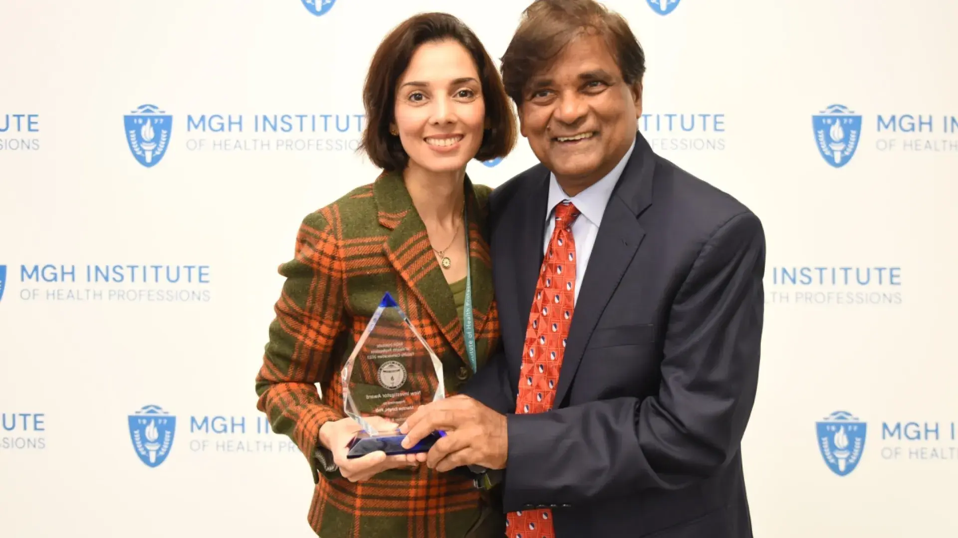 Woman and man smiling while standing