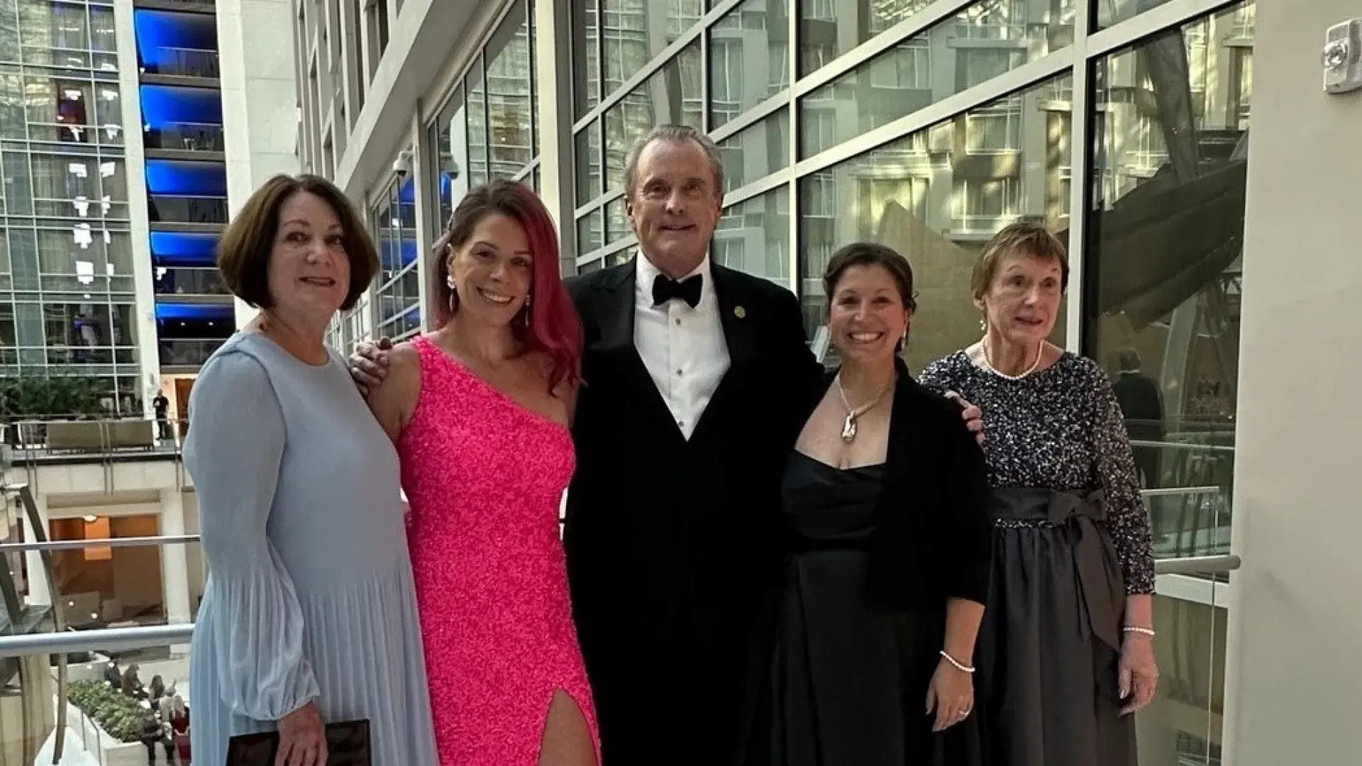 Dean Ken White stands with four women dressed up