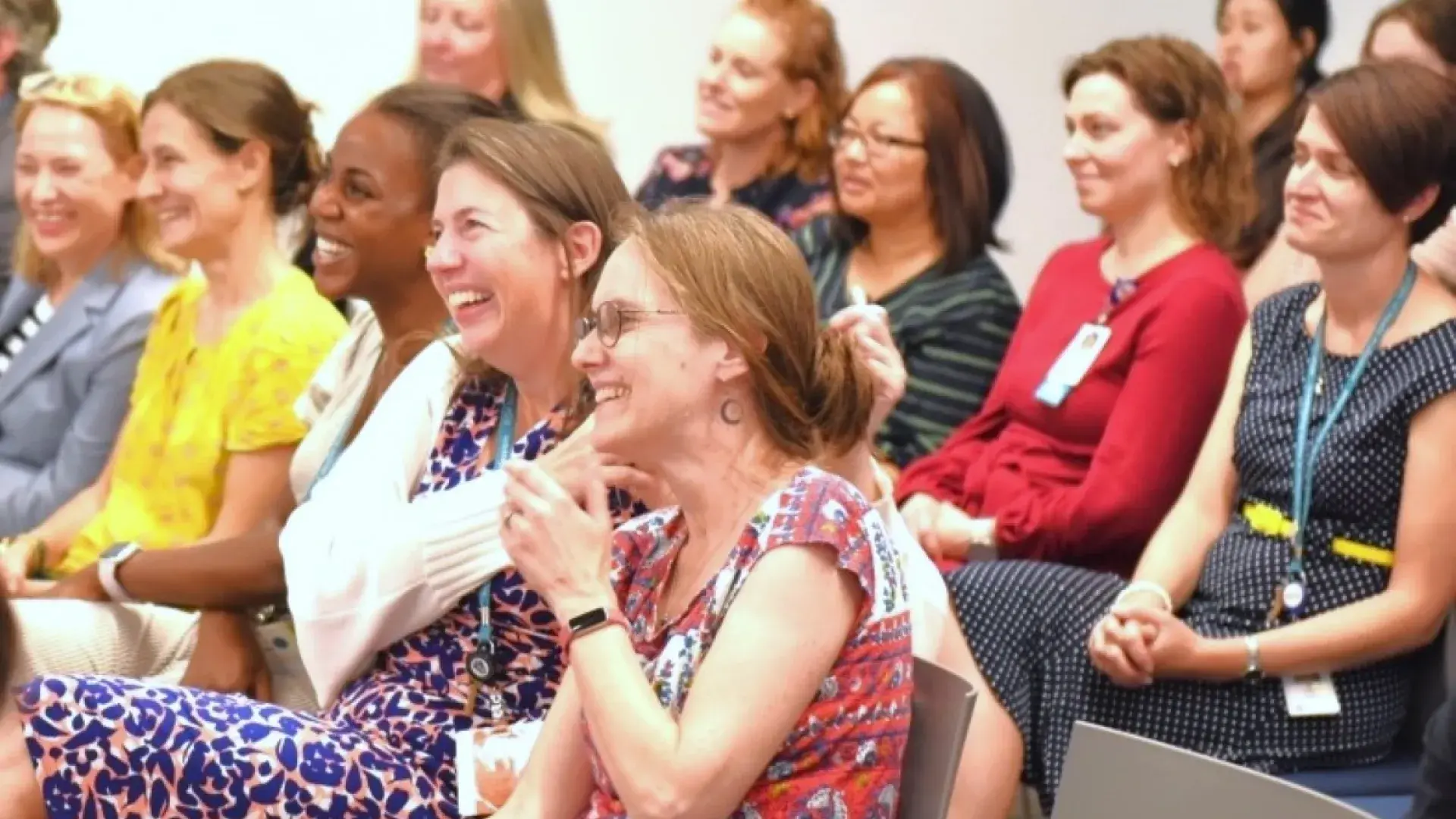 People smiling sitting in chairs