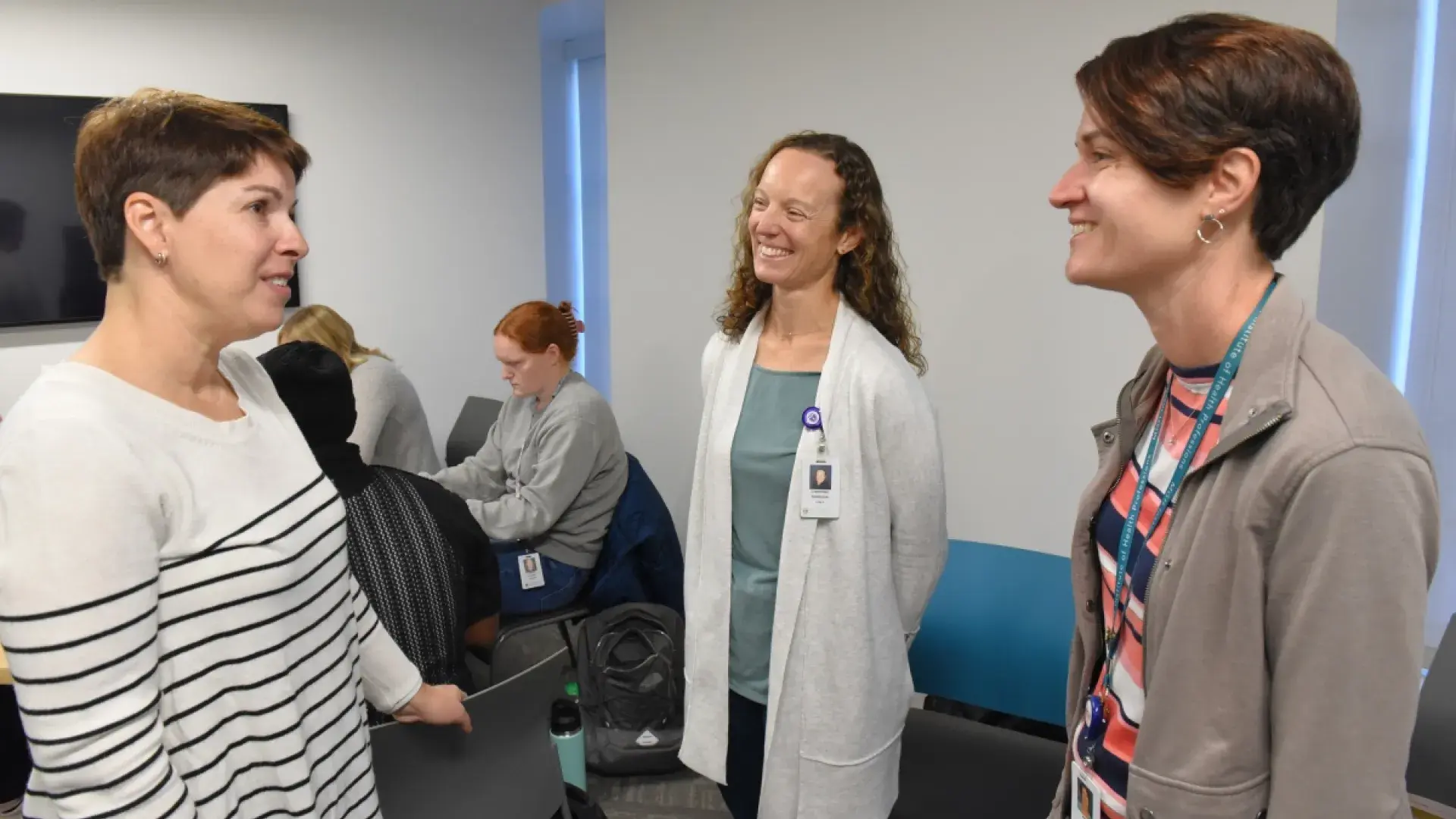3 people smiling and talking