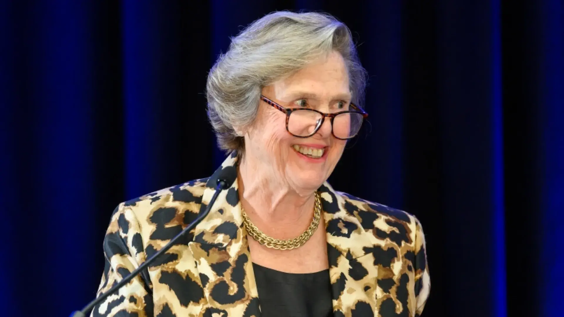 Woman with glasses speaking