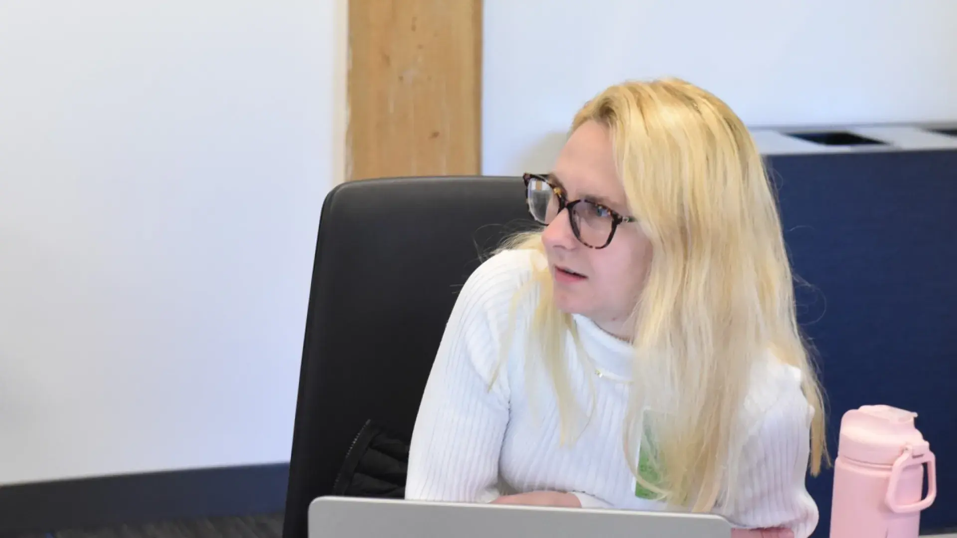 Woman with glasses looking to her right