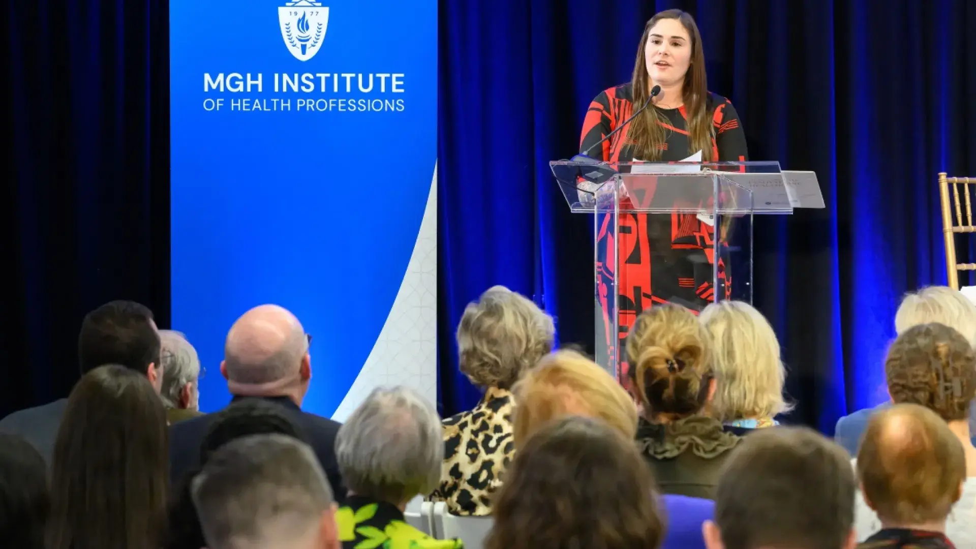 Woman speaking at a podium.