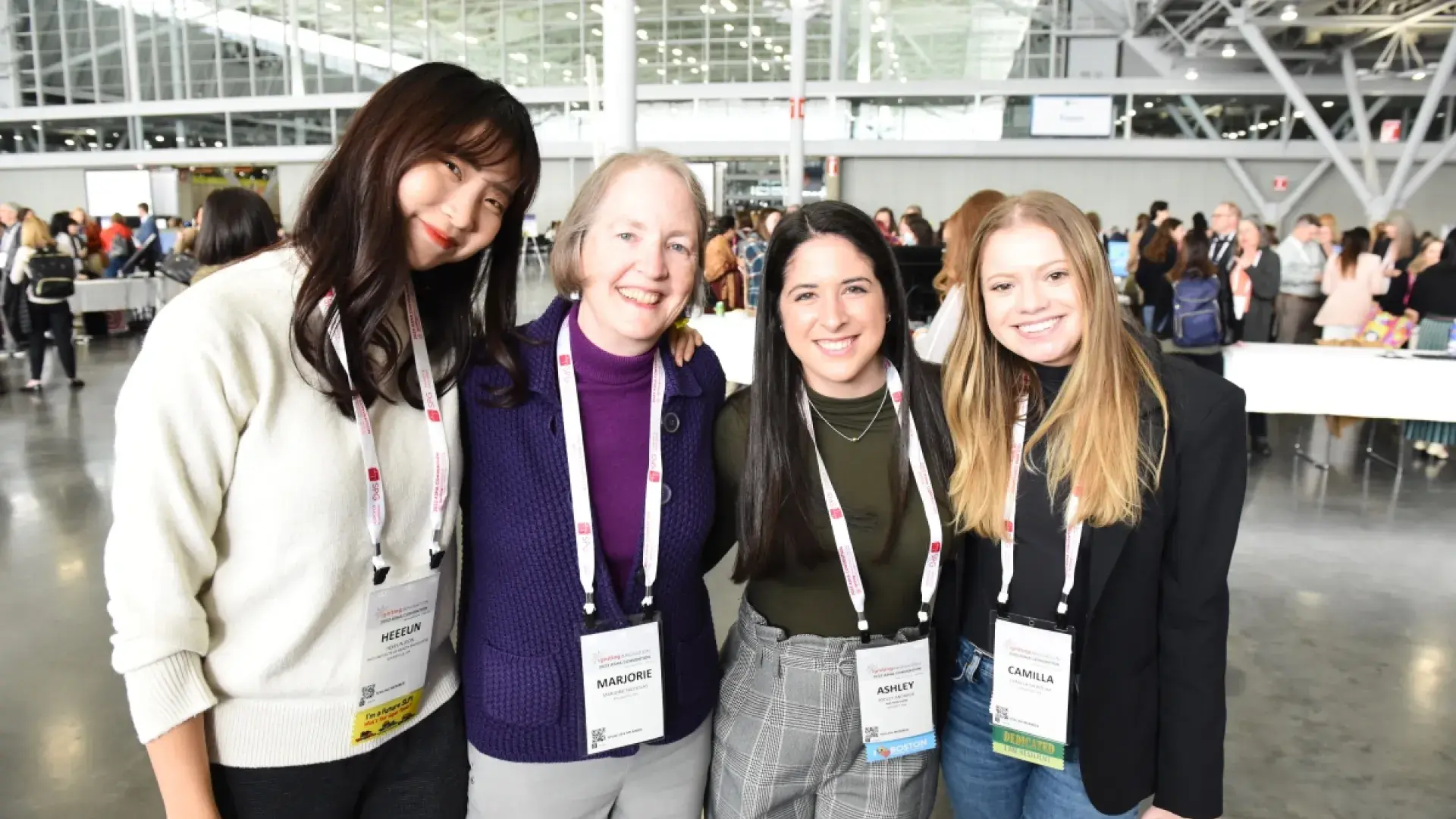 4 people smiling in a line