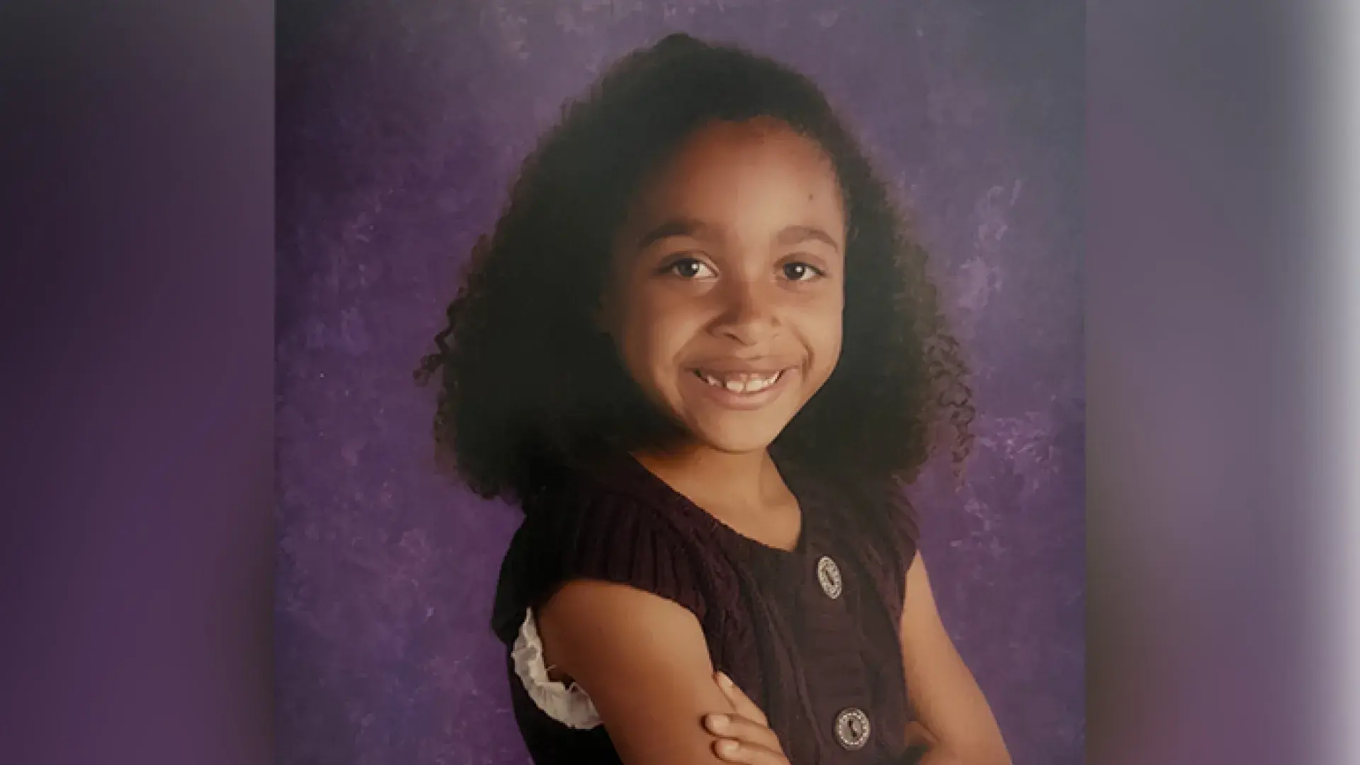 natalie has her arms folded and a big smile