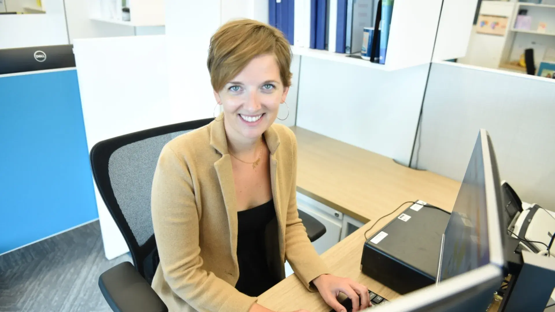 woman sitting at computer and smiling