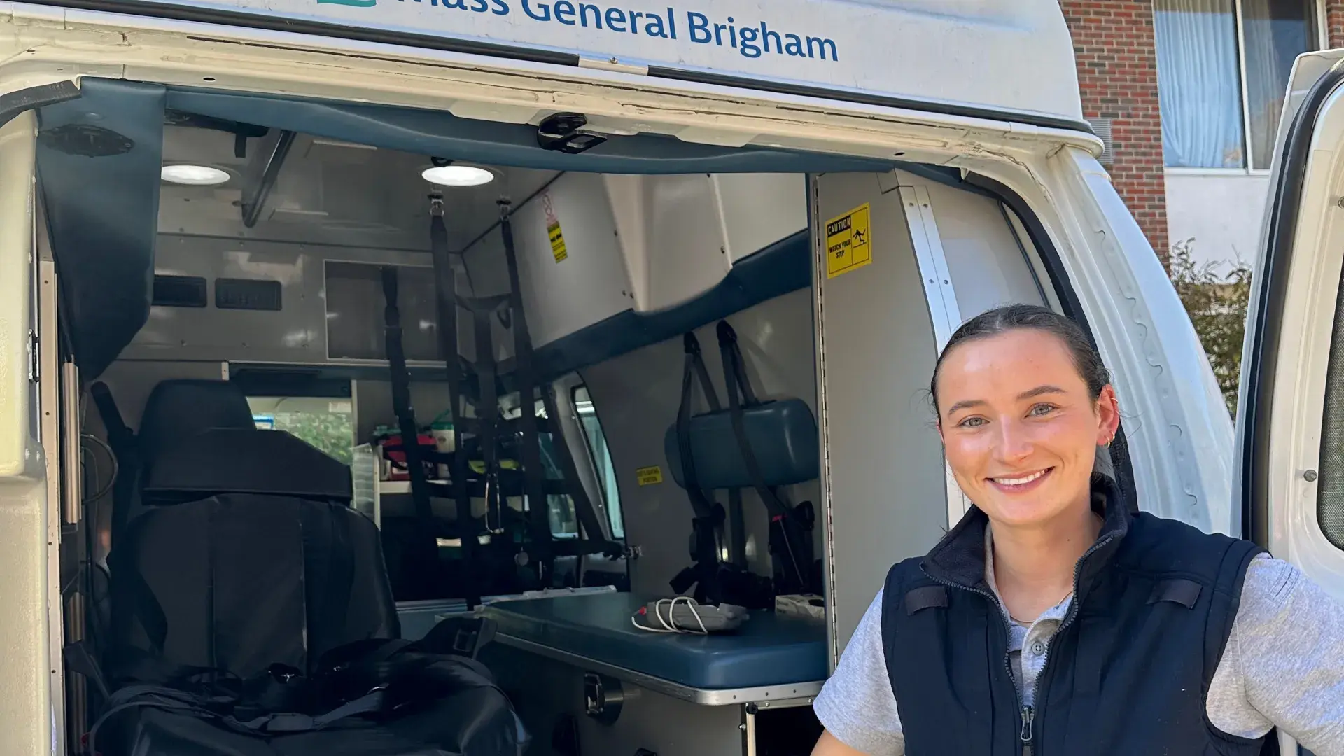 Woman standing with an ambulance