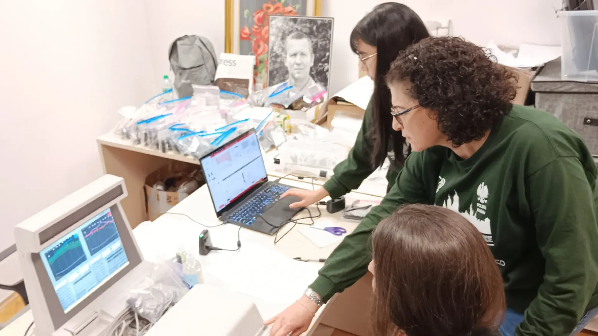 three women look at computers