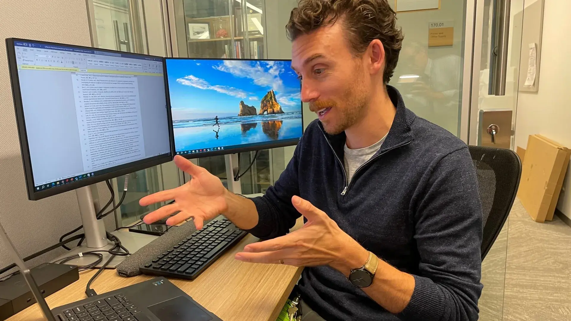 man talks at computer