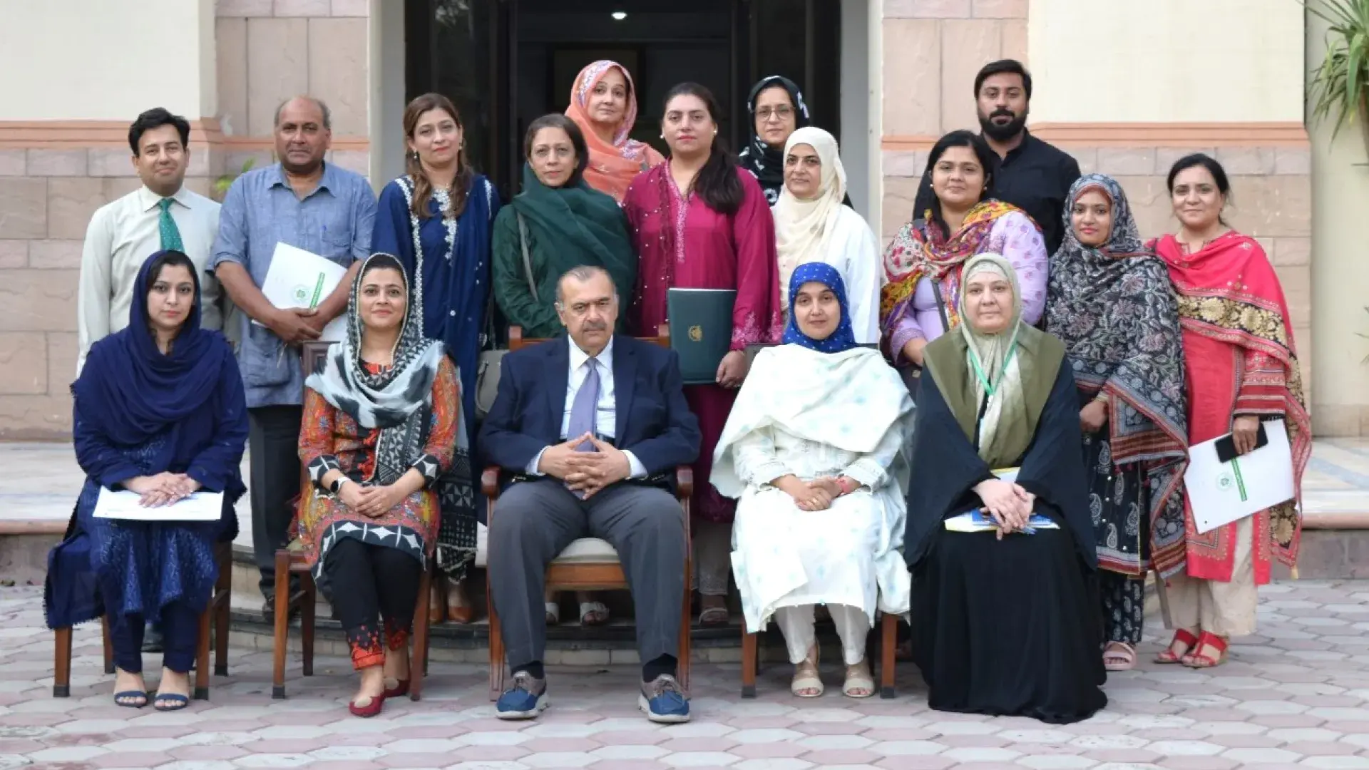 Large group of people pose for a photo in Pakistan