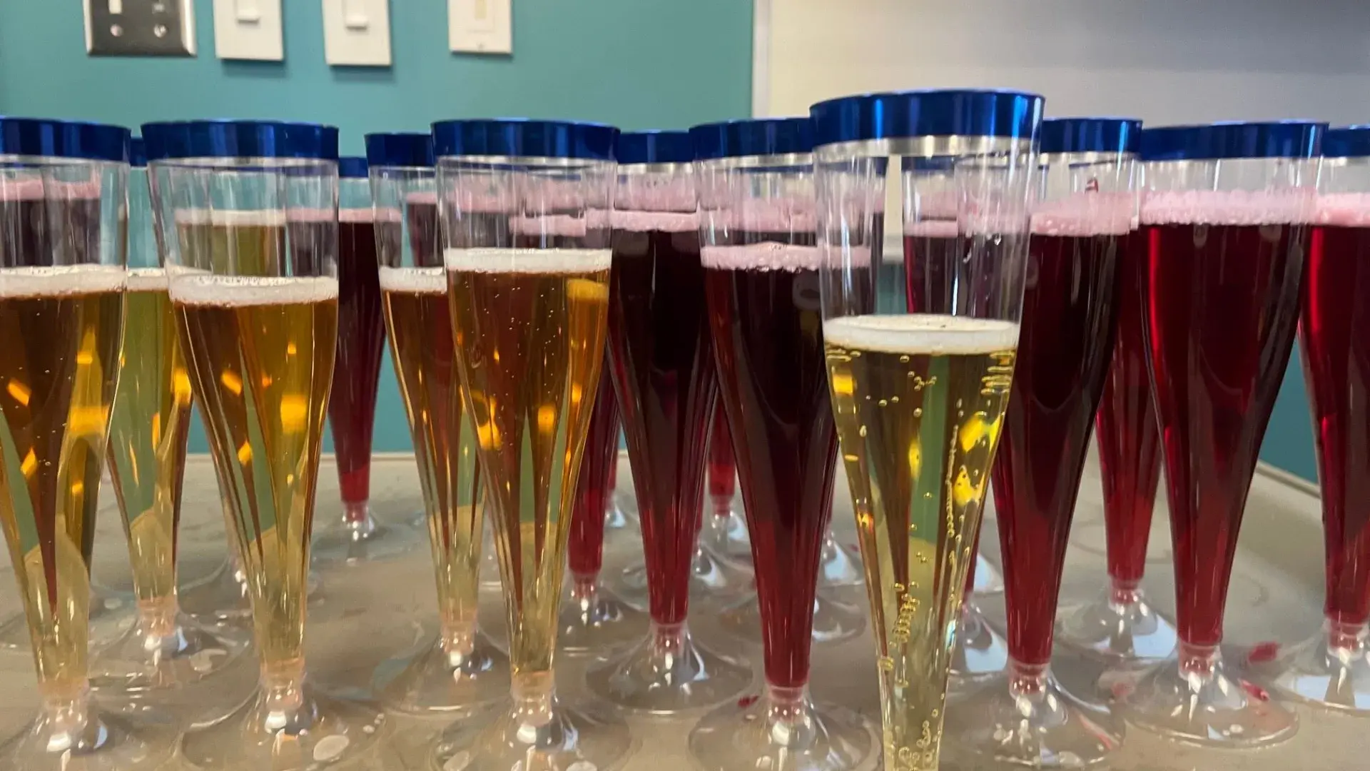 Champagne and sparkling juice glasses lined up for MGH IHP NCLEX celebration honoring the DEN Class of 2025's 100% first-time pass rate.