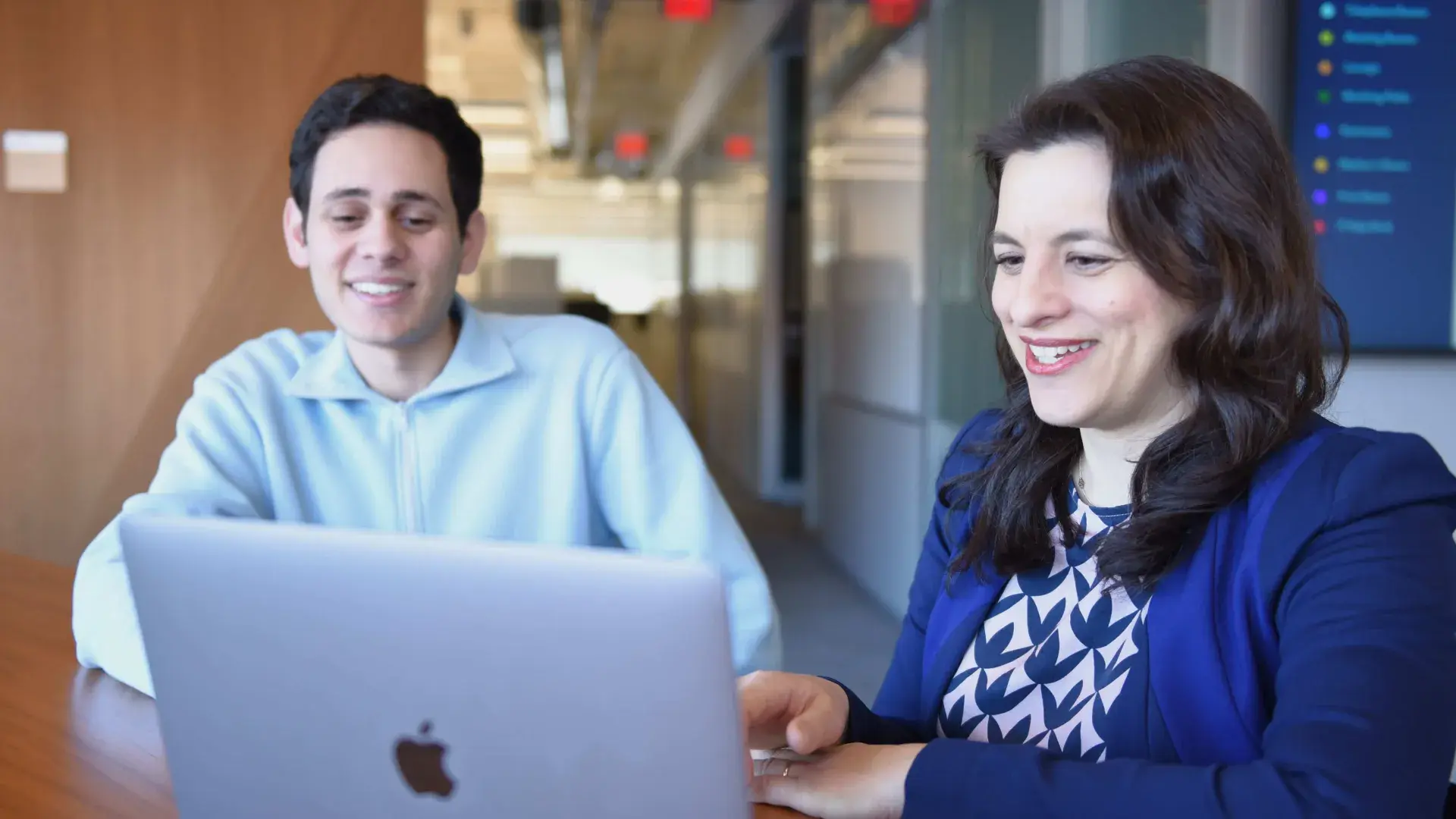 Two people looking at laptop