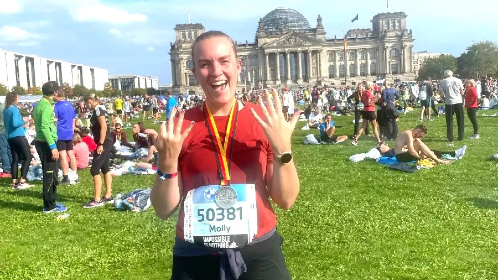 Woman smiles after completing a marathon.