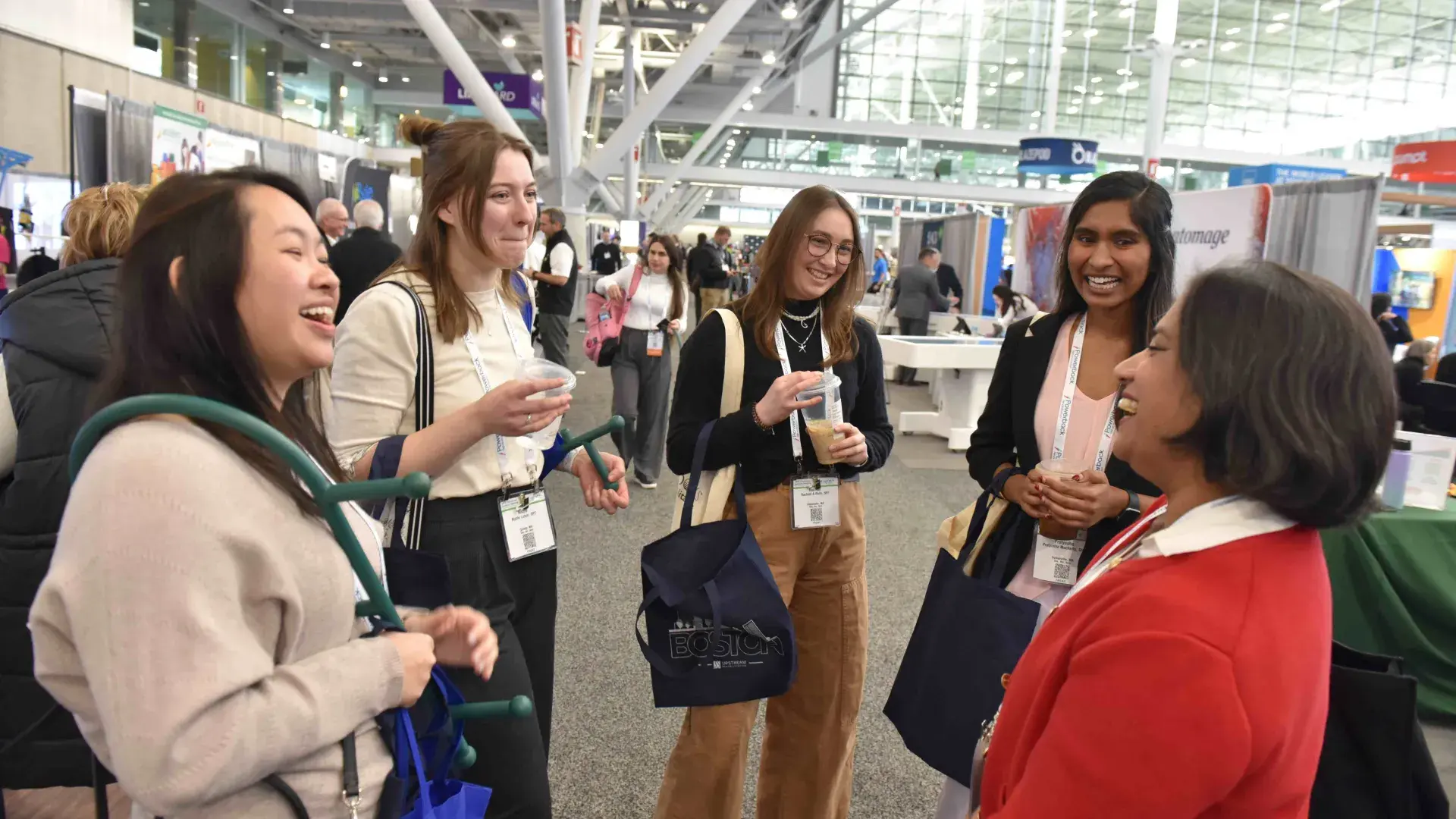 Five people standing and laughing