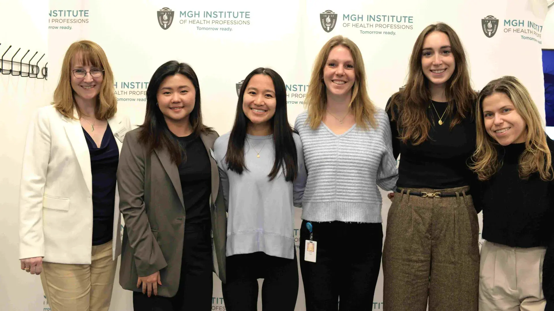 People smiling and standing in a row