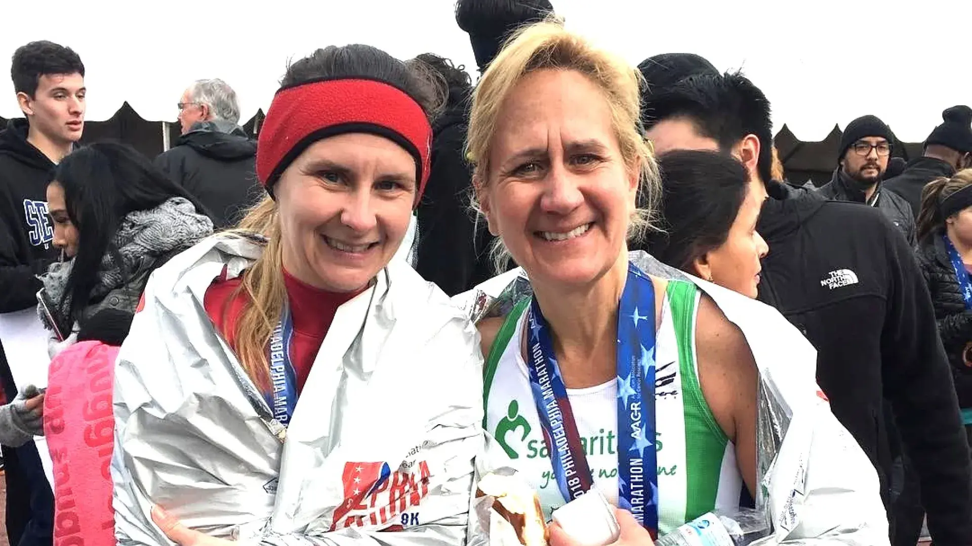 Two women smiling after running marathon