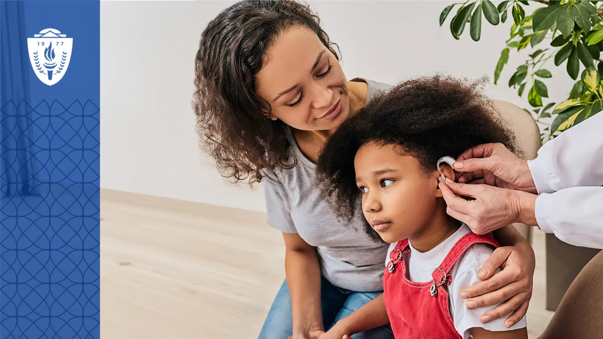 woman has arm around her daughter who is getting fitted for a hearing aid