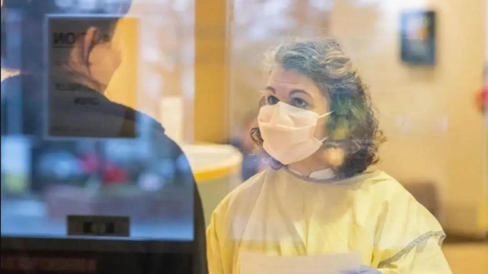 Woman in mask treating a patient