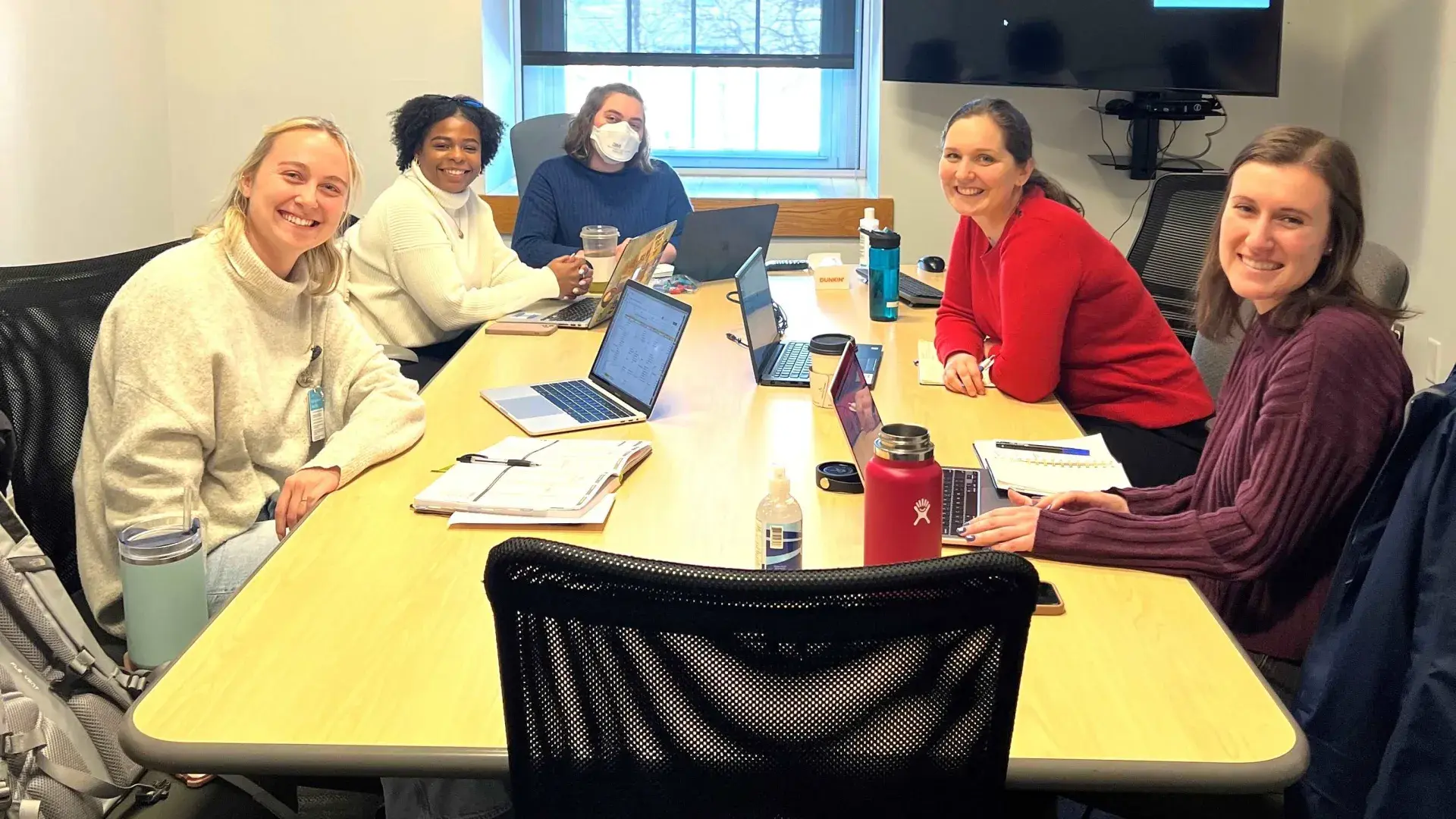 5 people sitting at a table