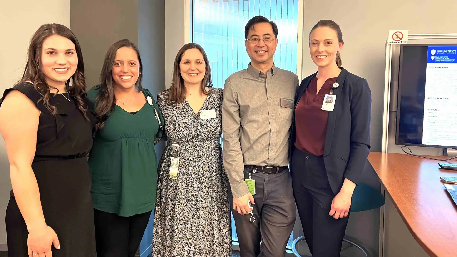 5 people standing and smiling