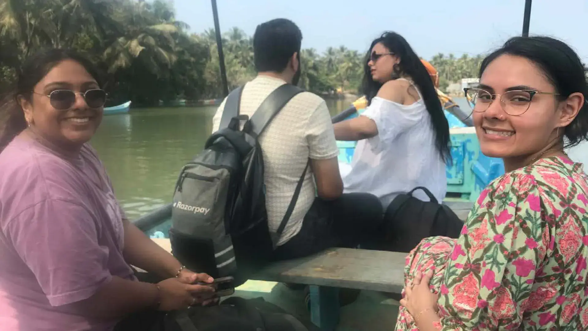 women smile on rowboat