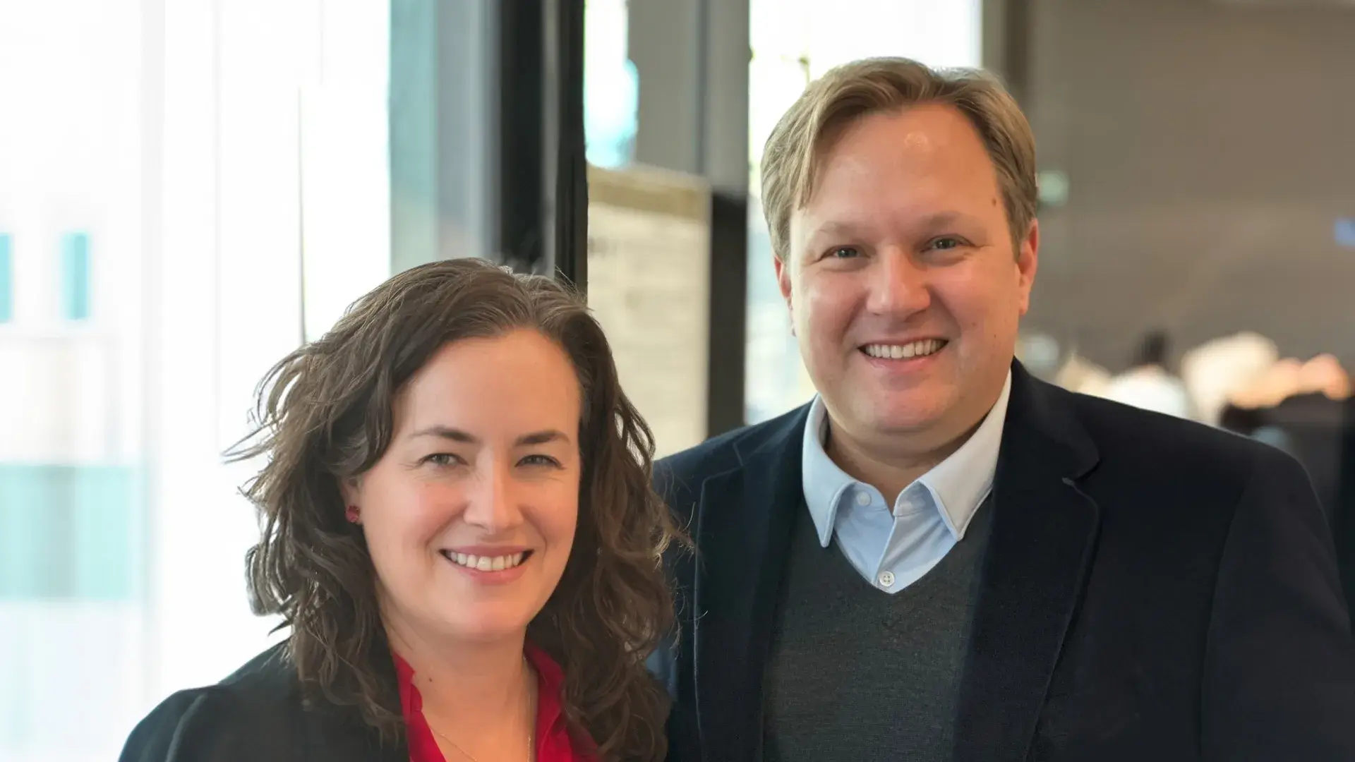 laura stands next to reamer with a dragon statue in her hand