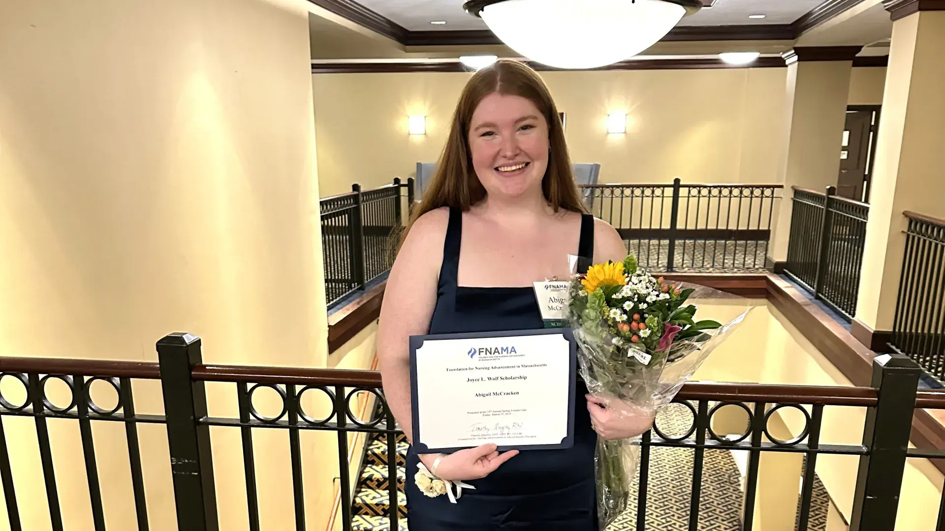 Woman smiling holding a certificate