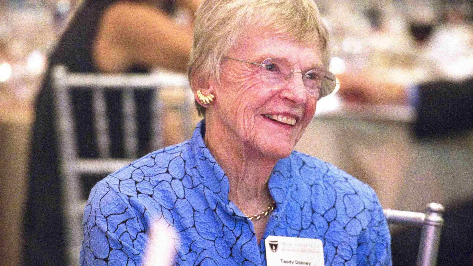 Woman sitting at table smiling