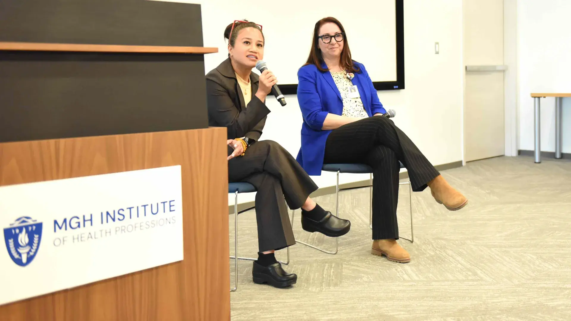 Two people talking on stage