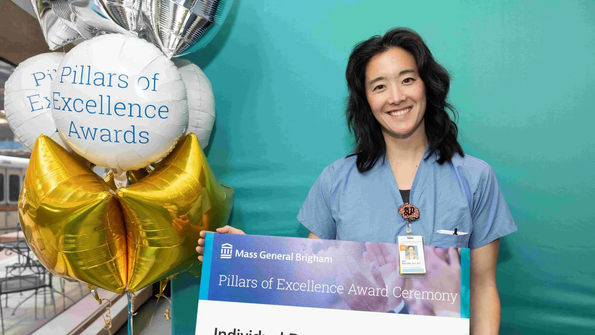 Woman in scrubs smiling