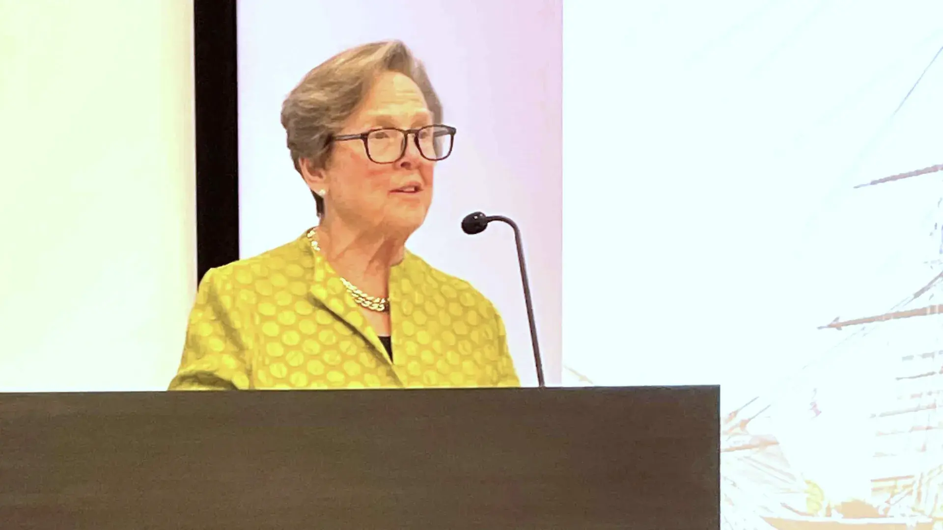 Woman speaking at a podium.
