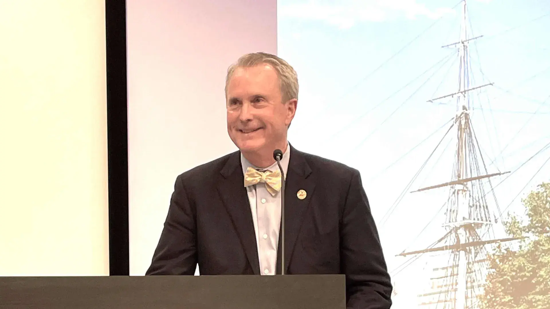 Man smiling at podium