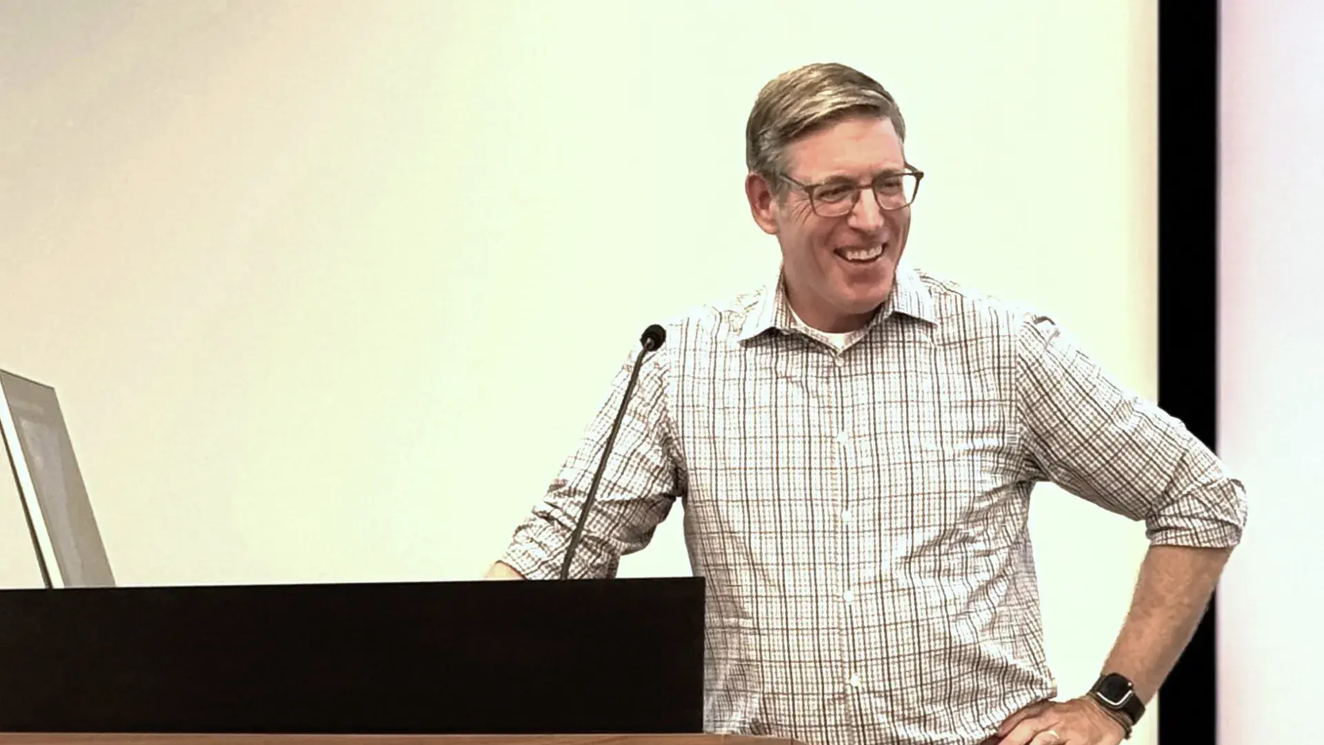 Man smiling at podiium