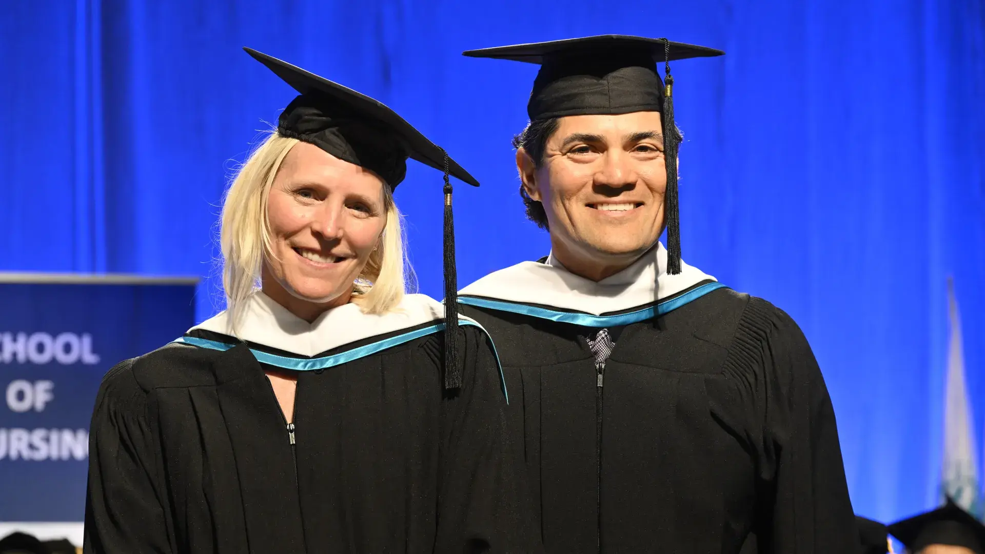 man and woman in cap and gown