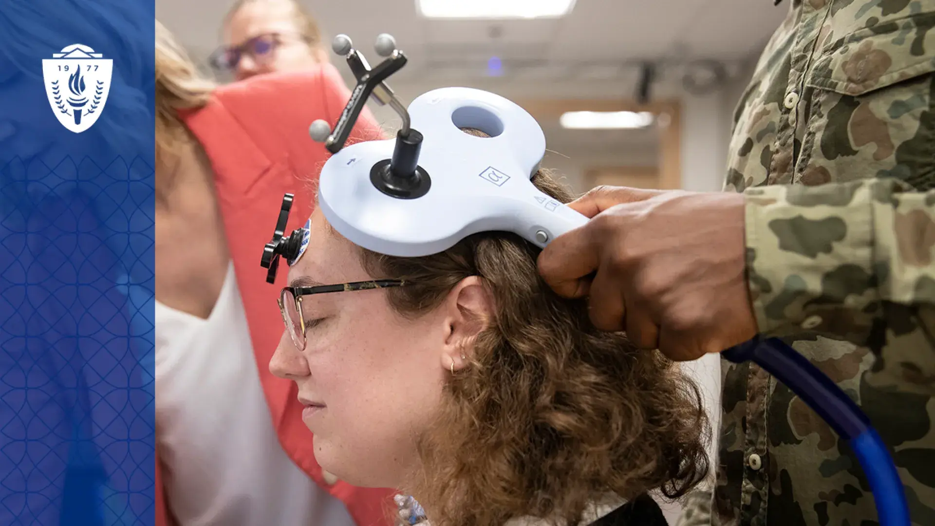 A physical therapy student practicing with advanced equipment