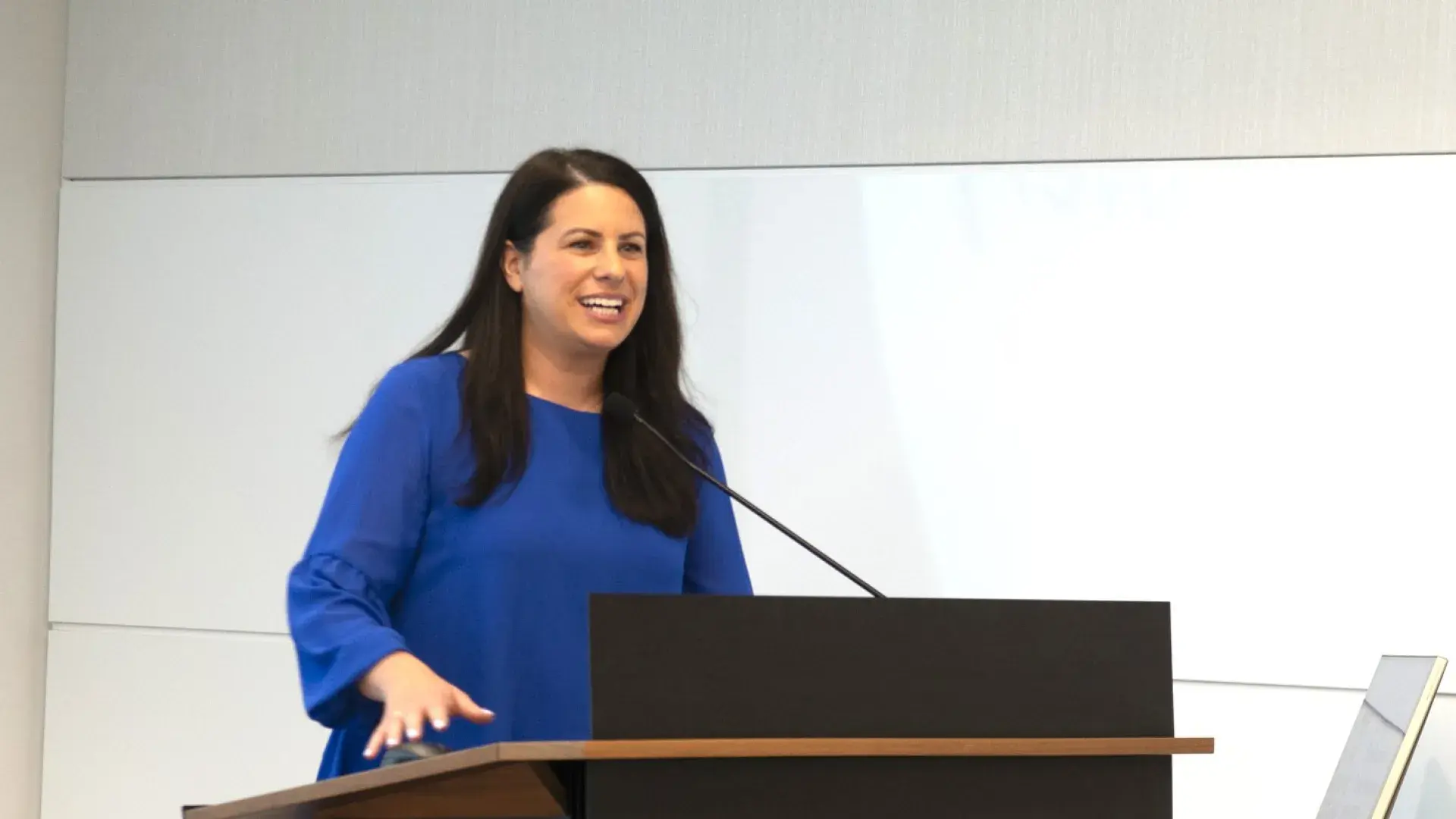 Woman smiling at podium