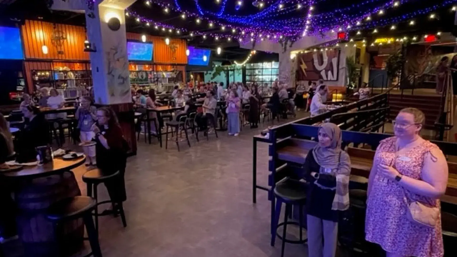 People standing and watching a presentation