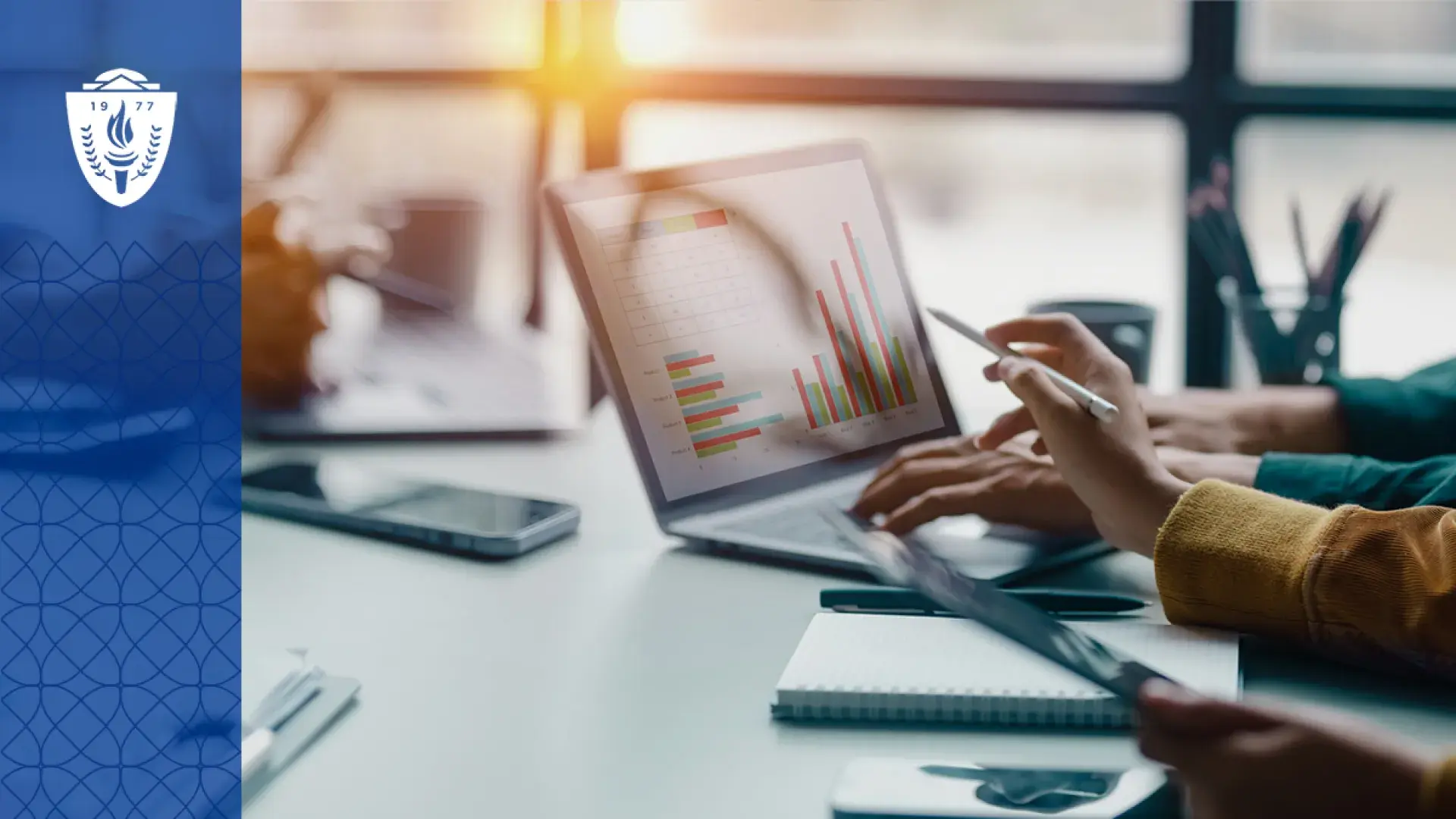 hands point at a graph on a laptop screen