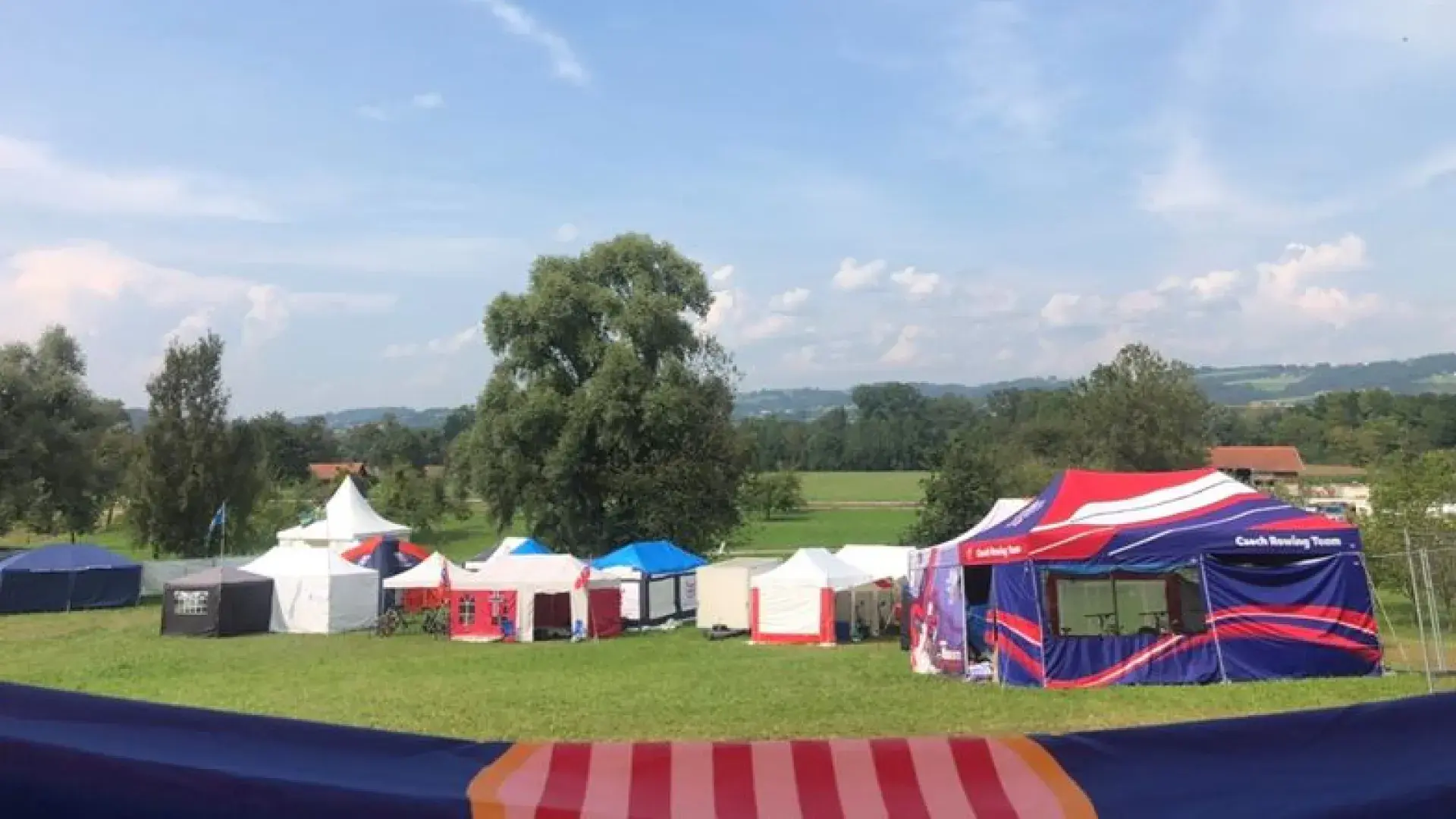 colorful tents sit in a green field