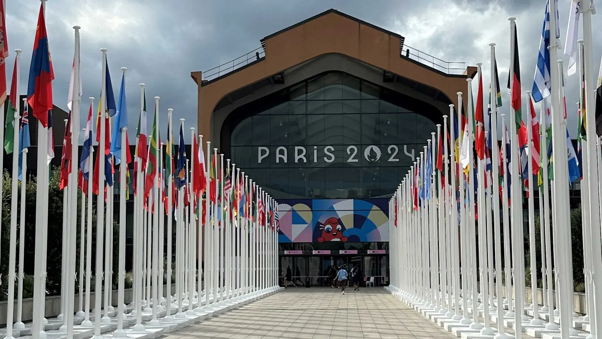 Dining hall between rows of international flags at the Athlete's Village.