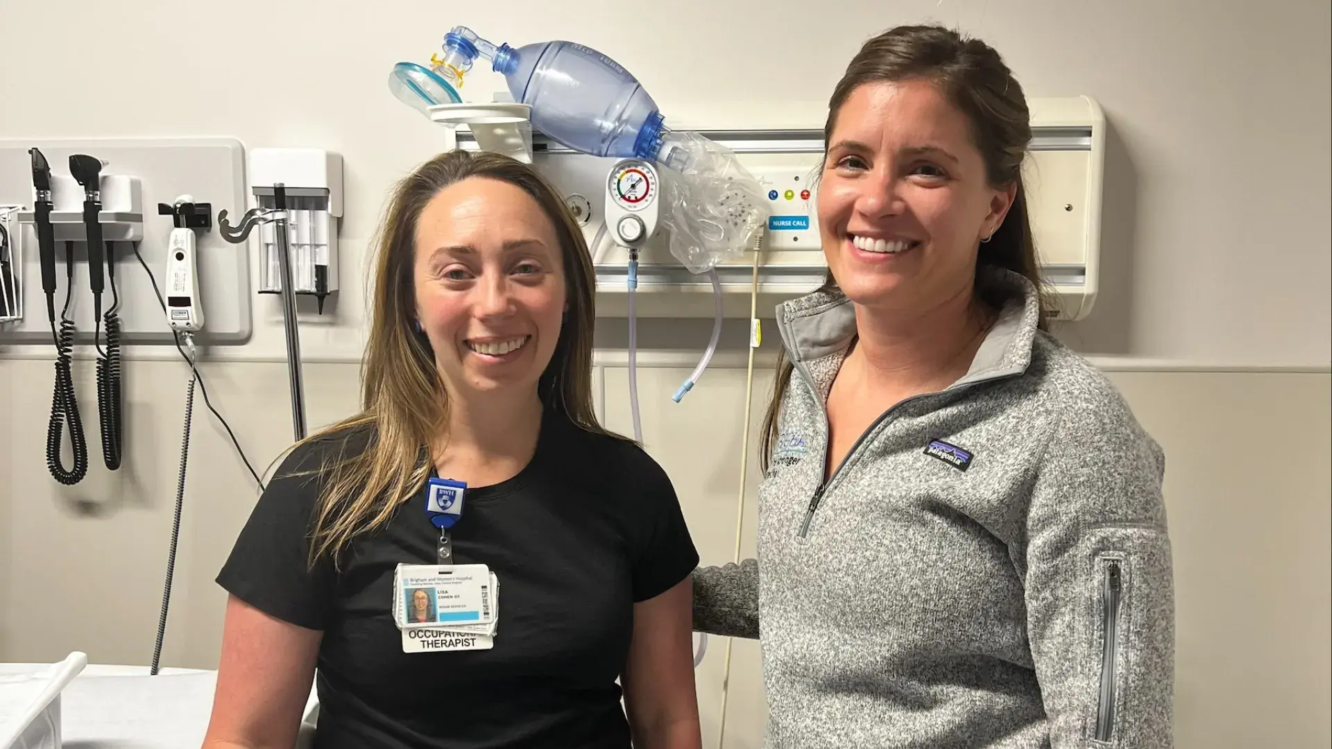 two women pose in a hospital room