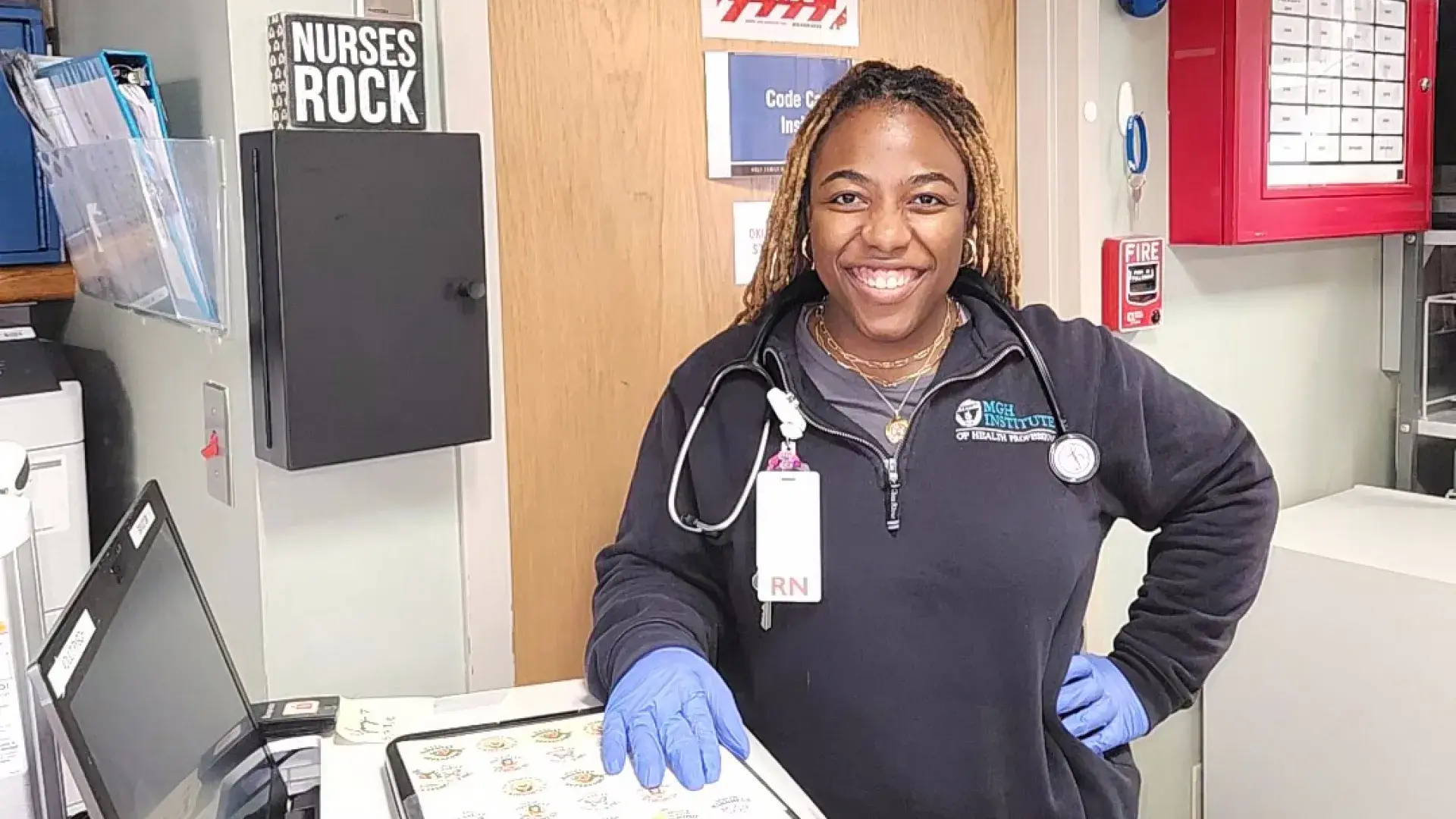 yonnie is in the hospital hallway she wears a stethoscope and rubber gloves
