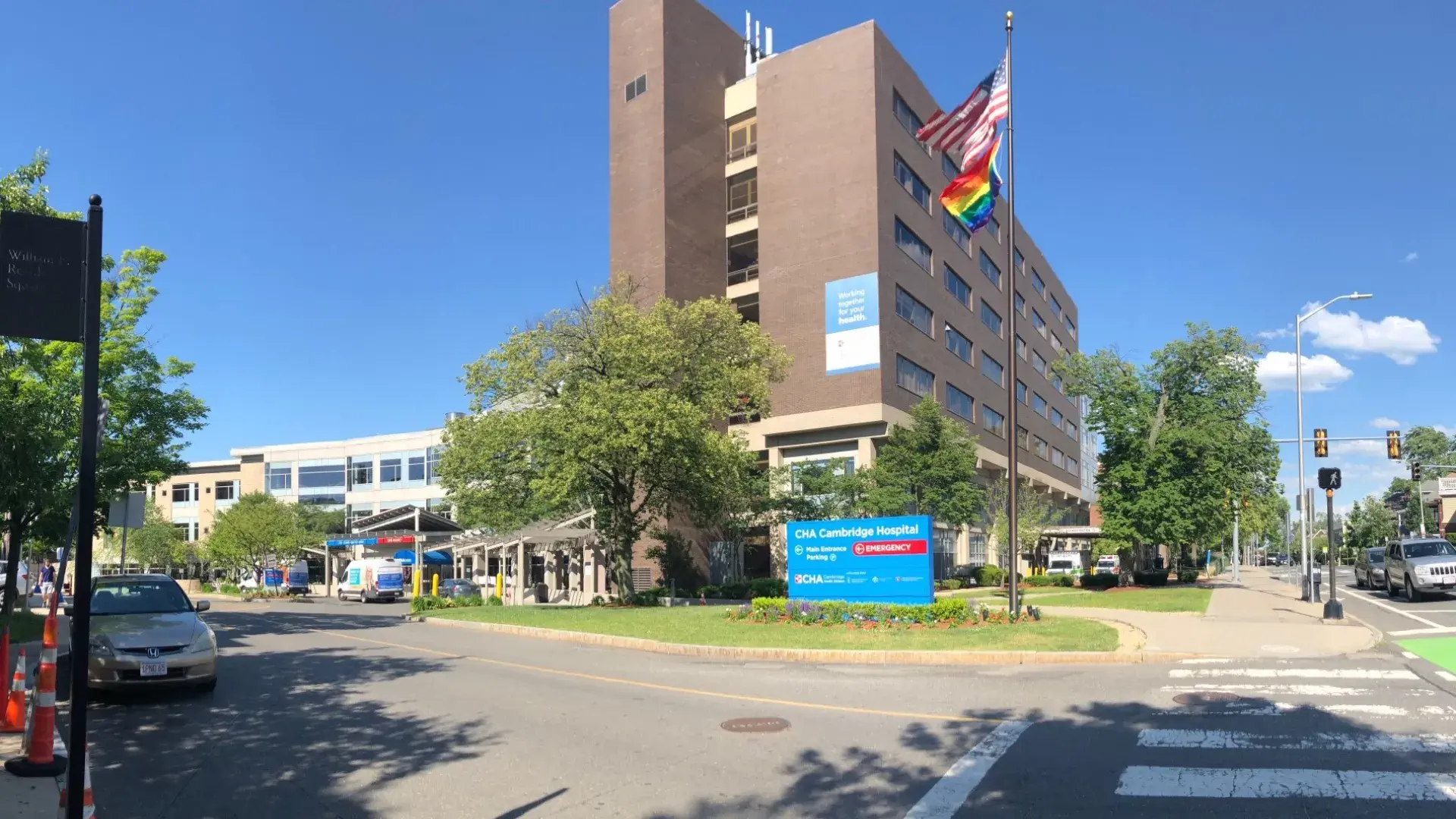 photo of a hospital with american and gay pride flags