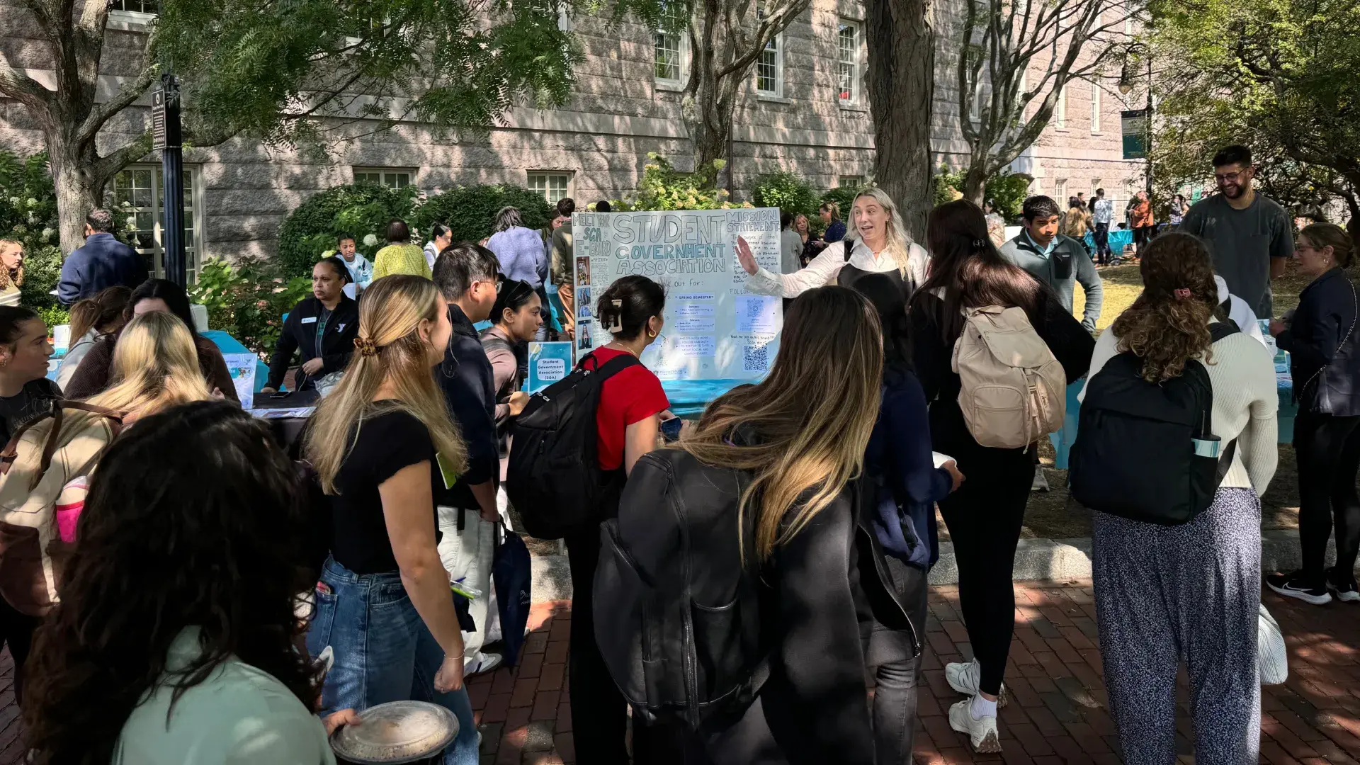 Crowd of people in front of poster board