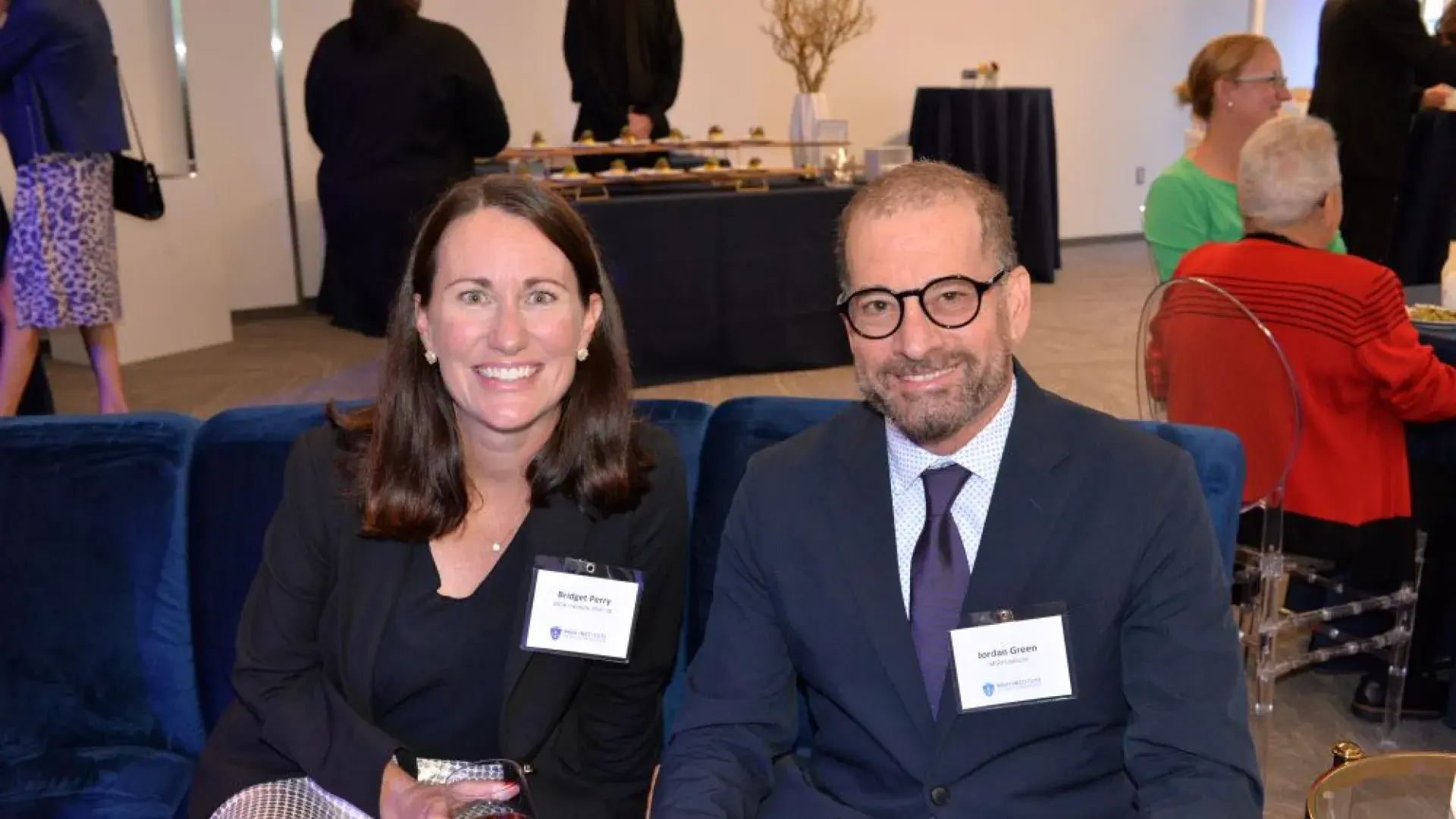 Two speech-language pathology researchers in formal attire posing for a group photo at the MGH Institute of Health Professions gala event