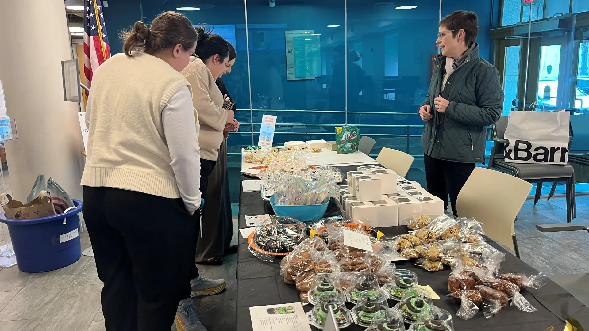 women standing at bake sale