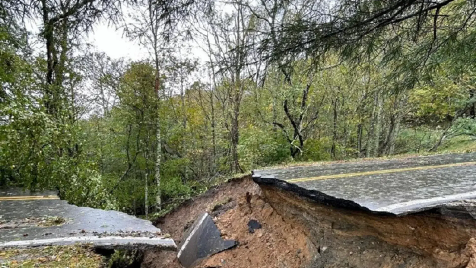 A road is cut in two after water washed part of it away