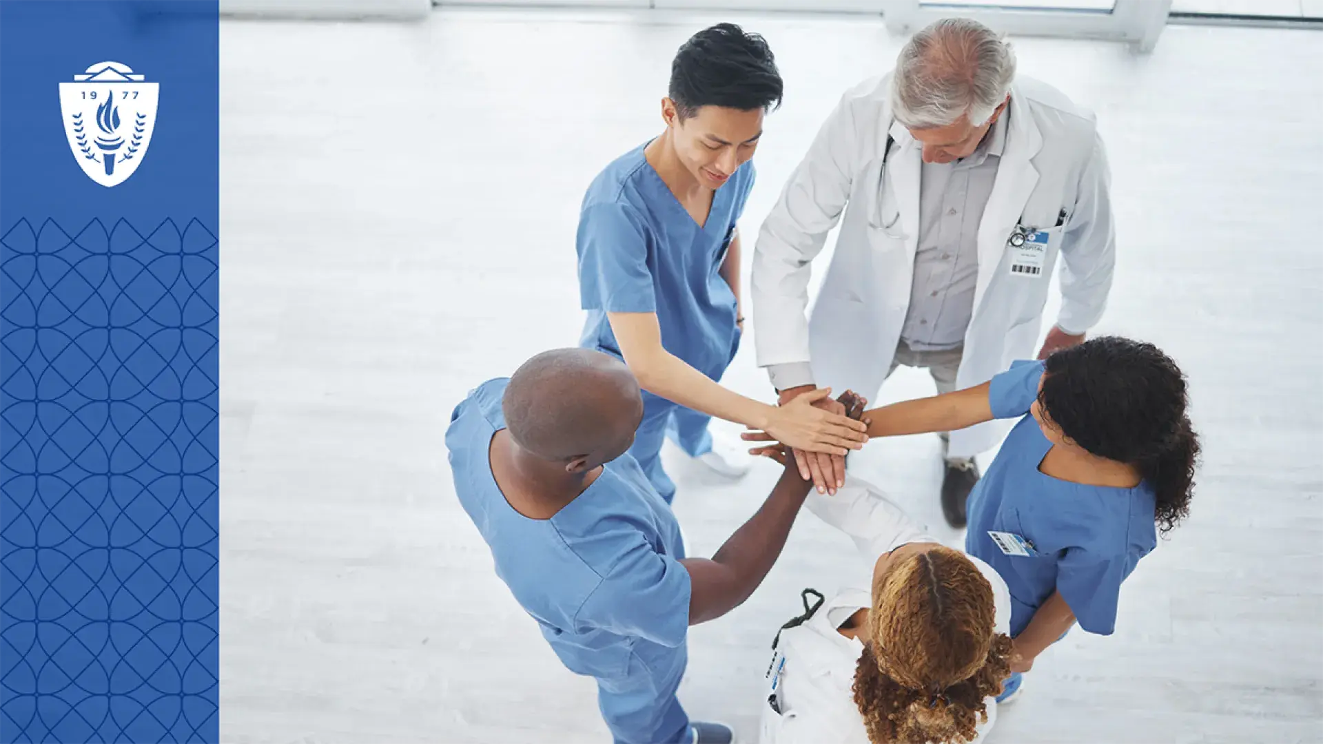 members of a healthcare team stand in a circle with their hands in representing teamwork