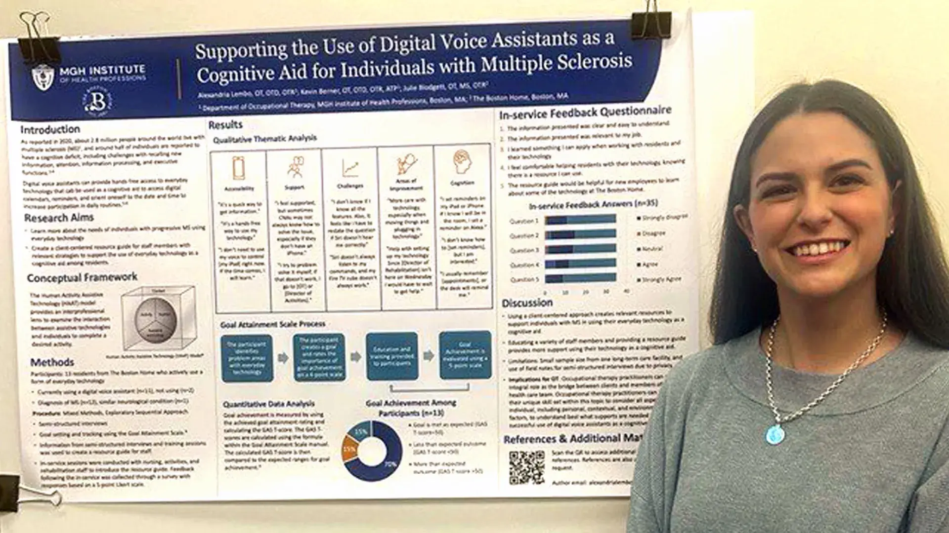 A woman stands in front of a poster at a research conference